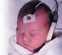 A baby getting a hearing screening test